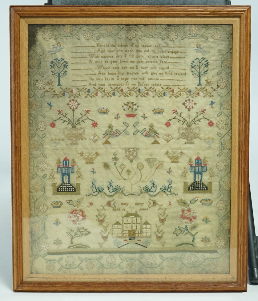 A large framed early 19th century sampler (undated), worked by Mary Berry. The sampler finely worked with angels either side of a verse and with spot motifs of crowns, birds, trees, deer and baskets of flowers. Either si